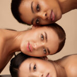 Portrait Of Three Diverse Women. African, Asian And Caucasian Girls Posing On Gray Background. Multi-Ethnic Female Beauty And Sensuality