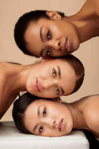 Portrait Of Three Diverse Women. African, Asian And Caucasian Girls Posing On Gray Background. Multi-Ethnic Female Beauty And Sensuality