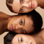Multiracial Beauty. Portrait Of Multiethnic Asian, African American And Caucasian Women Looking At Camera Posing Over Gray Studio Background. Vertical